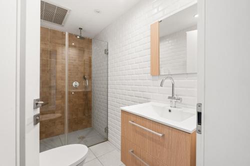 a bathroom with a toilet and a sink and a shower at Villa Marbella Eilat in Eilat