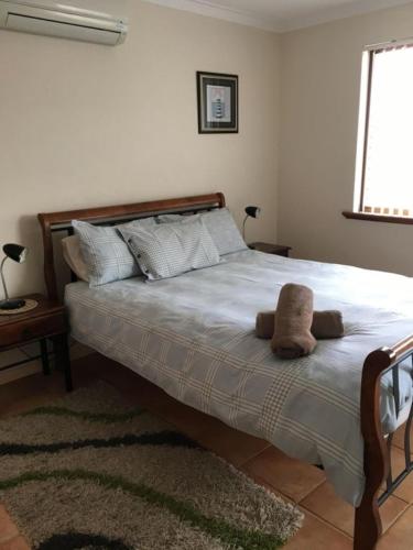 a bedroom with a large bed with two pillows at Seaview on Kent in Rockingham