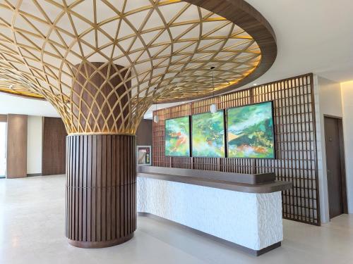 a lobby with a reception desk with a gold ceiling at oneTree Plaza Hotel Cebu in Cebu City