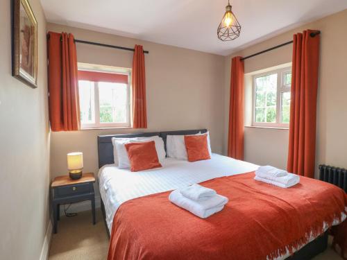 a bedroom with a bed with two towels on it at Ivet Lowe in Matlock