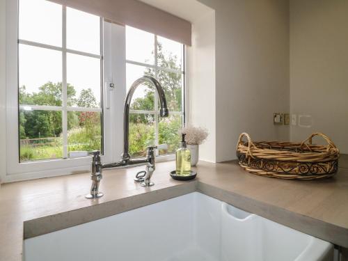 a kitchen with a sink and a window at Ivet Lowe in Matlock
