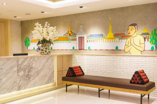 a waiting room with a bench and a mural at Koon Hotel Sukhumvit in Bangna
