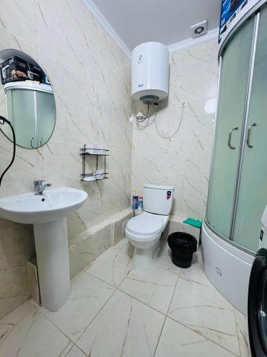 a bathroom with a sink and a toilet and a mirror at Balor152 in Koshkolʼ