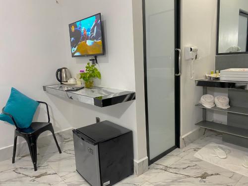 a room with a table and a chair and a mirror at Angkor Rise Residence in Siem Reap