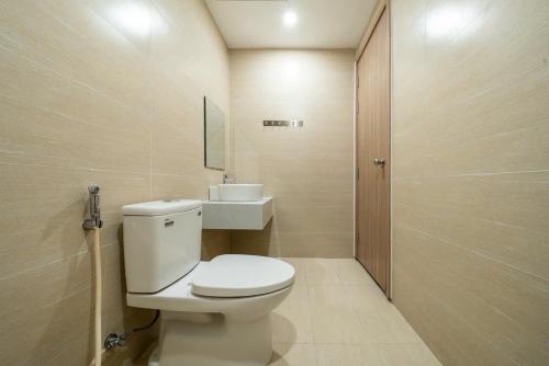 a bathroom with a white toilet and a mirror at Ina apartment - Nera garden Hue in Hue