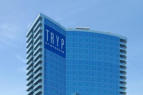 a tall blue building with the hynergy at TRYP by Wyndham Dubai in Dubai