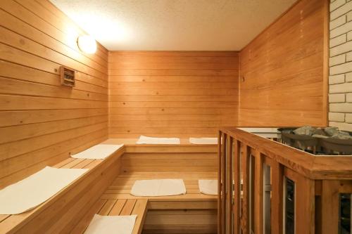 an empty sauna with wooden walls and wooden floors at Regions Hostel in Yokote