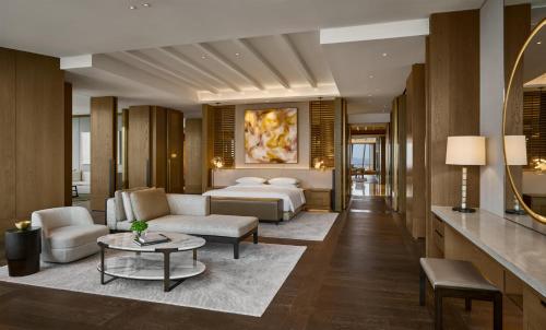 a hotel room with a bed and a couch at Park Hyatt Kuala Lumpur in Kuala Lumpur