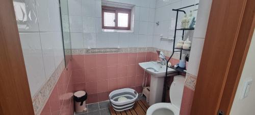 a bathroom with a toilet and a sink at Lunar House in Hyomoktong-Ilgu