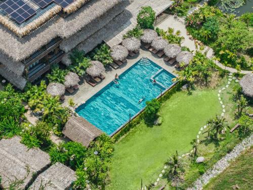 an overhead view of a swimming pool next to a house at Tam Coc Oasis Resort & Spa in Ninh Binh