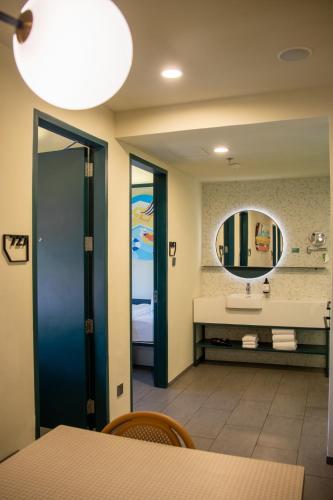 a bathroom with a sink and a mirror at lyf Cebu City managed by The Ascott Limited in Cebu City