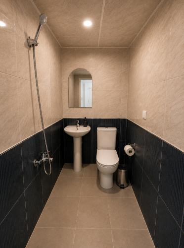 a bathroom with a toilet and a sink at Kennedy Apart Hotel Kumkapı Istanbul in Istanbul