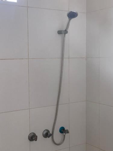 a shower with a shower head in a bathroom at CAAA Youth Hostel in Kibanguni