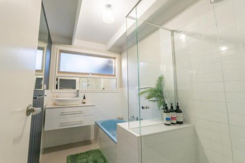 a bathroom with a glass shower and a sink at The Rye Reset in Rye