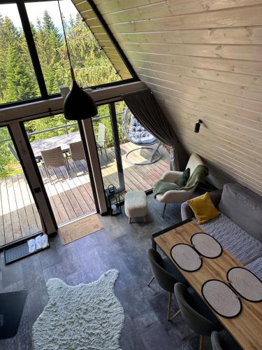 a living room with a couch and a table at Forest Huts in Yablunytsya