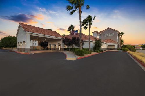 a house with a driveway in front of a building at Homewood Suites Lancaster in Lancaster