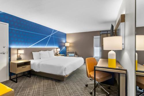 a hotel room with a bed and a desk at Comfort Inn Douglasville - Atlanta West in Douglasville