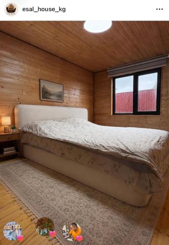 a bedroom with a large bed in a room at Esal house in Chon-Sary-Oy