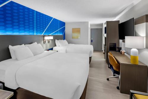 a hotel room with two beds and a desk at Comfort Inn Mount Vernon Downtown in Mount Vernon