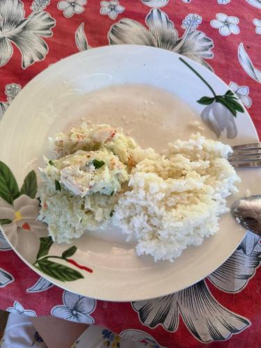 a plate of rice and meat on a table at Twin Beach Bungalows in Loh