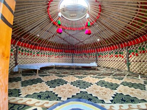 a room with a yurt with a bench in it at Azamat Yurt Camp in Song-Kul