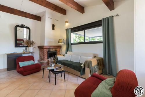 a living room with a couch and a fireplace at En sales in Saint-Jean-Lherm