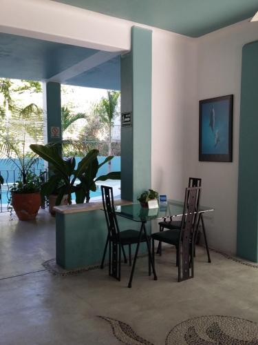 a dining room with a table and chairs at Delphinus Inn in Santa Cruz Huatulco