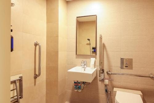 a bathroom with a sink and a toilet and a mirror at Newly Renovated - Days Inn by Wyndham Singapore Novena in Singapore