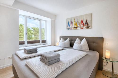 two beds in a room with a window at Ferienwohnung Aquamarin im Haus Arkona Prora in Binz