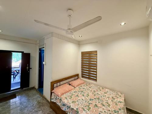 a bedroom with a bed and a ceiling fan at Kp's Riverland Resorts in Madwa