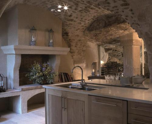 a kitchen with a sink and a counter top at Le Moulin des Sources in Gordes