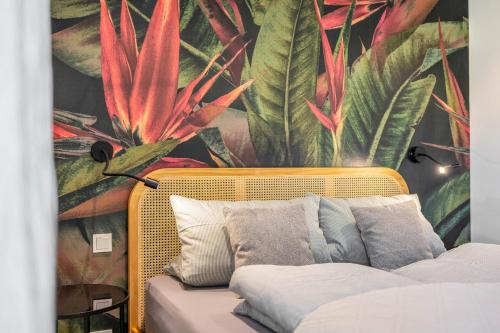 a room with a couch and a mural of plants at Apartment Nest 20 in Ettenheim
