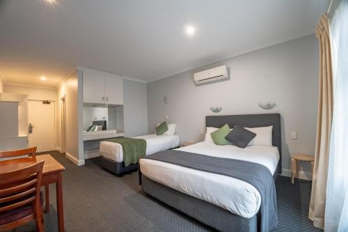 a hotel room with two beds and a table at St Francis Winery in Old Reynella