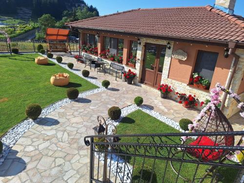 a model of a house with a garden and a building at Perla Guest House in Dospat