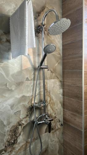 a shower with a shower head in a bathroom at Casa Acati Venus in Venus
