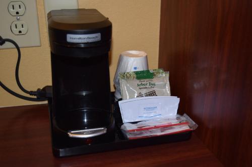 a coffee maker sitting on top of a table at Microtel Inn & Suites by Wyndham Rock Hill/Charlotte Area in Rock Hill