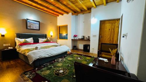 a bedroom with a bed and a green rug at Arhat Resort in Deskit