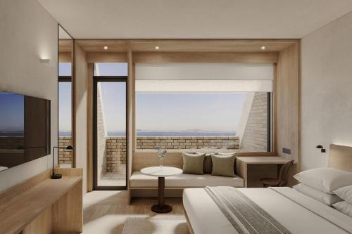 a bedroom with a bed and a large window at The Cape Town EDITION in Cape Town