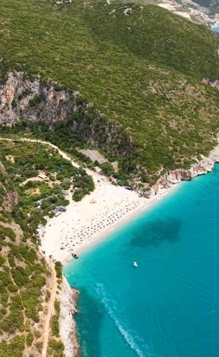 an aerial view of a beach with blue water at Gjipe eco campground 2 in Ilias