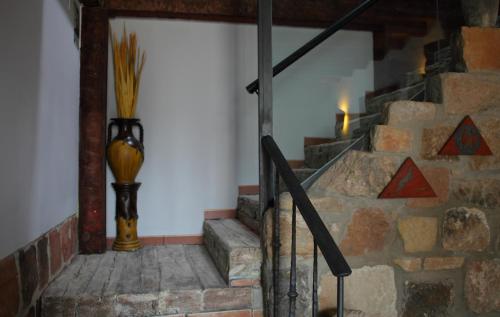 a set of stairs with a vase on the wall at Douris Temple in Soria