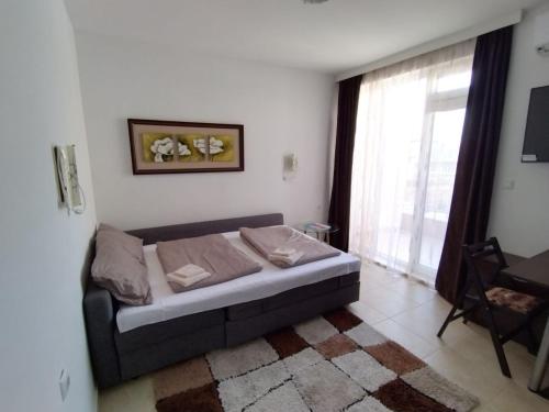 a bedroom with a bed in a room with a window at Comfy Home in Pomorie