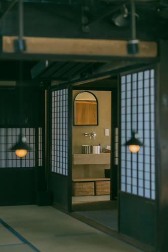 a bathroom with a sink and a mirror at 暇家 kaya in Yosano