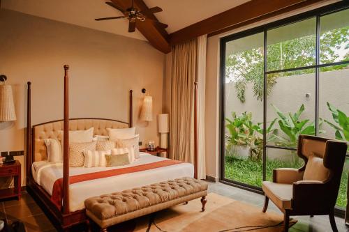 a bedroom with a bed and a large window at Arth Resorts I Convention I Wellness in Moinabad