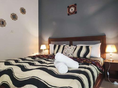 a bedroom with a large bed with pillows on it at Lois Beach Resort in Nyanyanu