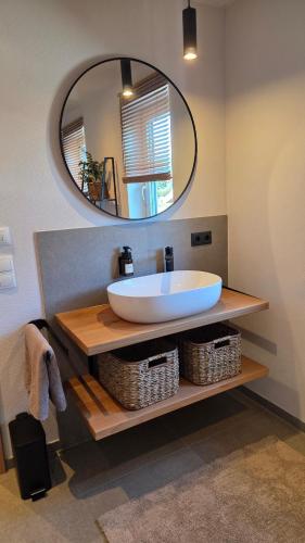 a bathroom with a large sink and a mirror at Bachwagnerhof in Staudach-Egerndach