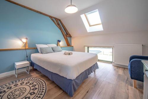 a bedroom with a large bed and a window at Les Grandes Vagastines in Saint-Germain-du-Plain