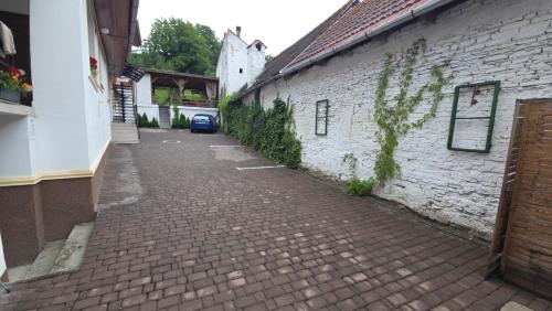 a brick alley between two buildings with a building at Casa Vanatorului in Sighişoara