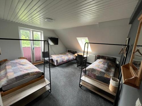 a bedroom with two bunk beds and a window at Lüly in Lütjensee