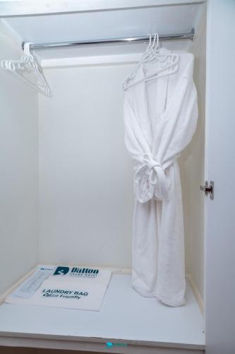 a closet with white towels and a box in it at The Dalton Grand Hotel in Murangʼa