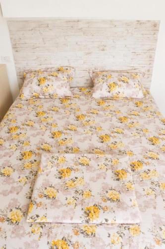 a bed with flowers on it in a bedroom at Luxury Beachfront Villa with Pool and Jacuzzi in Hennchir Ksar Rhaleb